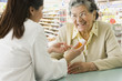 Senior Hispanic woman discussing medication with pharmacist