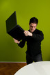 Foto: Frustrated man trashing laptop Frustrated man trashing laptop