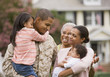 African American military father hugging family