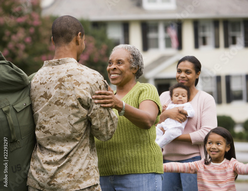 Photo: African American male soldier greeting family African American male soldier greeting family