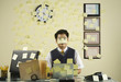 Asian businessman with sticky notes all over wall and face