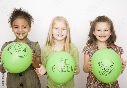 Photo: Multi-ethnic girls holding green balloons Multi-ethnic girls holding green balloons