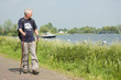 Senior man doing a Nordic Walk on a sunny day.