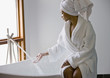 African woman filling bathtub