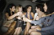 Multi-ethnic women toasting with champagne