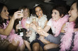 Multi-ethnic bachelorette party toasting with champagne