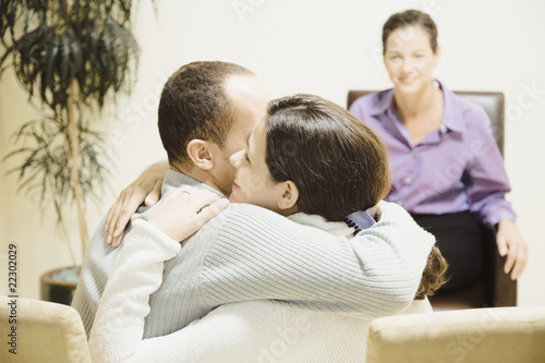 Photo: Multi-ethnic couple hugging at therapy session Multi-ethnic couple hugging at therapy session