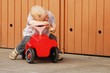 Foto: Child sitting on a red car Child sitting on a red car