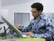 African graphic designer working on computer in office
