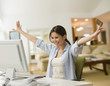 Cheering woman shopping online with credit card