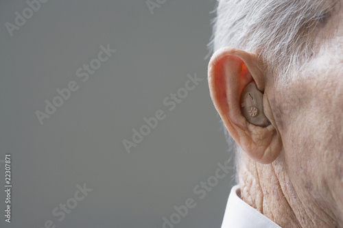 Photo: Close up of senior Hispanic manÕs hearing aid Close up of senior Hispanic manÕs hearing aid
