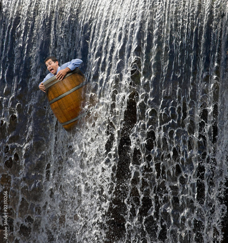 Photo: Businessman going over waterfall in barrel Businessman going over waterfall in barrel