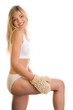 Woman massaging her leg with sisal glove