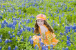 Little Girl Playing In Field of Flowers