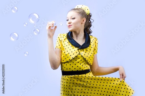 Foto: beautiful young woman blowing soap bubbles beautiful young woman blowing soap bubbles
