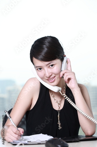 Photo: young asian business woman writing something young asian business woman writing something