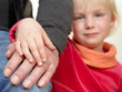 Sad girl holding the hand of her grandfather