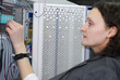 Woman working on telecommunication equipment