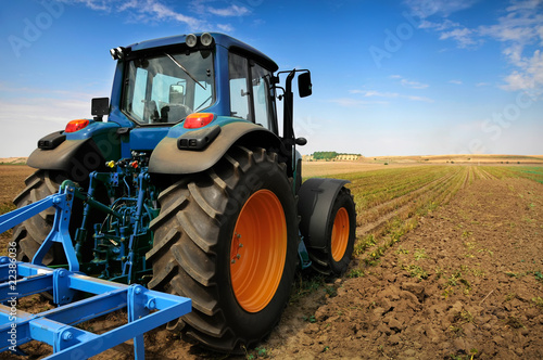 Photo: The Tractor - modern farm equipment in field The Tractor - modern farm equipment in field