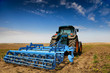 Photo: The Tractor - modern farm equipment in field The Tractor - modern farm equipment in field