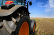 Photo: The Tractor - modern farm equipment in field The Tractor - modern farm equipment in field