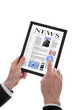 male hand holding a touchpad pc showing a newspaper