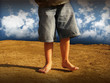 Little boy walking in desert