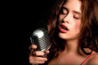 Beautiful singer singing with microphone