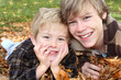 Brother's laying  in a pile of leaves