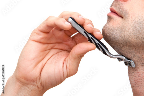 Photo: Man shaving with a razorblade Man shaving with a razorblade