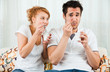 young, beauty girl and a handsome boy eating yoghurt