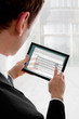 Businessman holding a touchpad pc, writing an e-mail