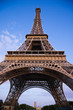 Wide angle of the Eiffel Tower against a deep blue sky