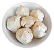 Cloves of garlic on white dish.