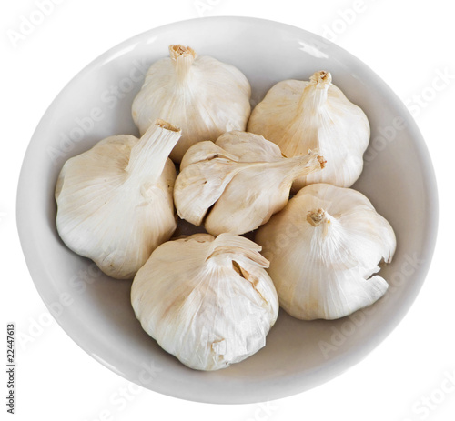 Photo: Cloves of garlic on white dish. Cloves of garlic on white dish.