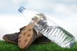 Black soccer shoes and water bottle on grass
