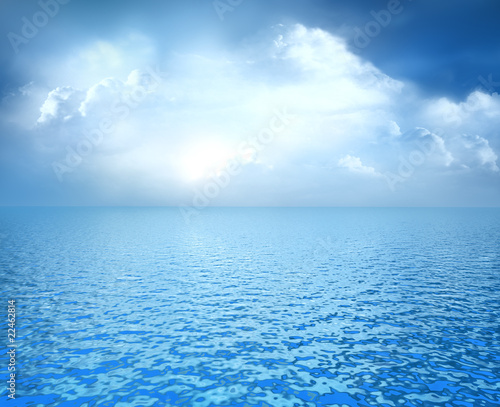 Photo: Blue ocean with white clouds on horizon Blue ocean with white clouds on horizon
