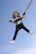 Photo: Young girl playing on bungee trampoline Young girl playing on bungee trampoline