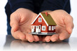 Hands and small house.