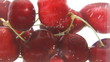 Cherries splash in the water
