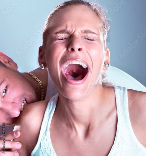 Photo: Wild boy bite women shoulder, woman screeming Wild boy bite women shoulder, woman screeming