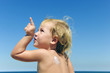cute child with sunscreen  at the beach