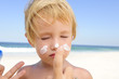 cute child with sunscreen  at the beach