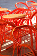Orange metal chairs and table in daylight