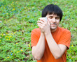 Man with cup of coffee on green  background