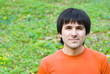 Young man on green nature background