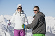 Young couple of skiers smiling at camera