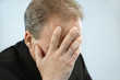 Businessman covering face