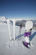 Skis and snowboard stuck in the snow