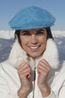 Young woman in winter clothes smiling at camera